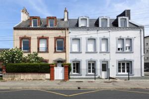 a white house with a white door on a street at La Hague - Second Souffle - Cherbourg in Cherbourg en Cotentin