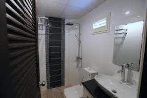 a bathroom with a toilet and a sink and a shower at The Pattaya Sports Hub in Pattaya Central