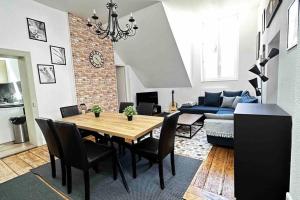 a living room with a table and a couch at Belle Isle - Grand appart - 6 Places - T3 - 72m2 in Metz