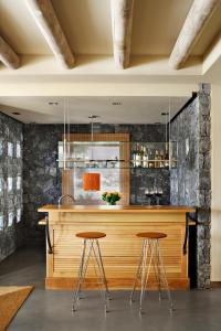 a kitchen with a bar with two stools at The Villas at Bahia del Duque in Adeje