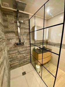 a bathroom with a shower with a glass wall at ''Sienne'' Superbe T4 climatisé à 2 pas des Halles ! in Sète