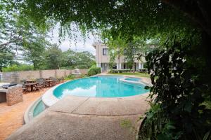 a swimming pool in the backyard of a house at Pristine deluxe room with kitchen and pool - 2147 in Victoria Falls