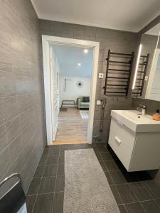 a bathroom with a sink and a mirror and a hallway at 2 bedroom apartment in Falun - 2km from centrum in Falun