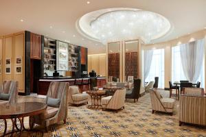 a hotel lobby with tables and chairs and a bar at Sheraton Petaling Jaya Hotel in Petaling Jaya