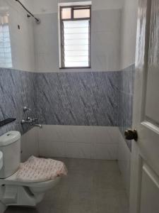 a bathroom with a toilet and a window at Cinnamon House in Pune +36 photos