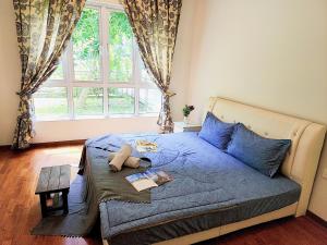a bedroom with a bed with a teddy bear on it at IPOH All Suite Resort, Jalan Haven, Persiaran Lembah Perpaduan, Ipoh Perak in Ipoh