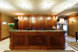 a large wooden bar in a hotel lobby at Panska Gora in Lviv