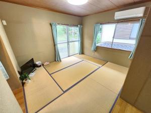 an empty room with a room with two windows at Ohama House in Sumoto +26 photos