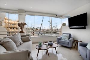 a living room with a couch and a large window at Puerto Marina exclusive apartment in Benalmádena