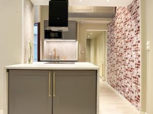 a kitchen with a counter and a brick wall at Luxury apartement in Oslo in Oslo