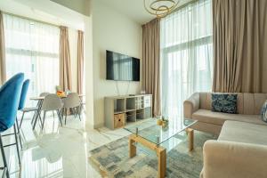 a living room with a couch and a table at AWS Homes - Luxurious 2BR with Burj views in Business Bay in Dubai