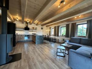 a large living room with a couch and a kitchen at Chalupa Jizerka in Plavy