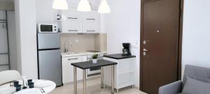 a small kitchen with a table and a refrigerator at Crete Apart House - South in Ayía Marína