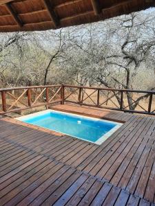 a small swimming pool on a wooden deck at Habibi Holiday Home in Marloth Park