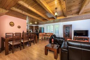 a living room with a table and a dining room at Oasis Mountain Villa in Braşov