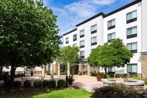 a large white building with trees and a courtyard at Courtyard by Marriott Boise West/Meridian in Boise