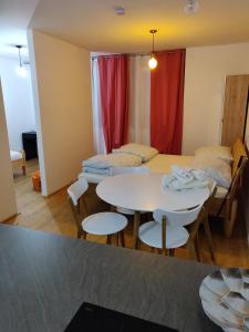 a room with two beds and a table and chairs at Private Parking-Top Retreat Residence in Vienna - Long Stays available in Vienna