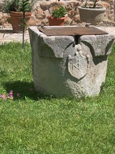 a stone bench with a table on the grass at guesthouse Libertas 3 in Dubrovnik