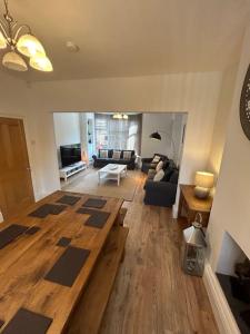 a living room with a couch and a table at Beautiful 4BR Home near Chester Racecourse in Chester