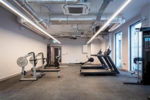 a gym with treadmills and cardio equipment in a room at Coleman Court Summer Accommodation in Cork