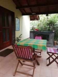 a table and chairs on a patio with a fireplace at MALLI'S VILLA in Koggala