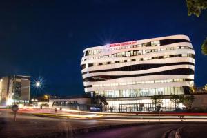 a building with a sign on top of it at night at Hilton Garden Inn Mbabane in Mbabane