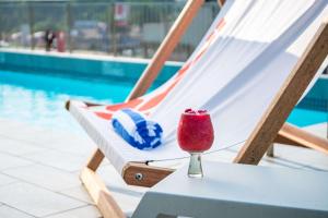 a drink sitting on a table next to a pool at Hilton Garden Inn Mbabane in Mbabane