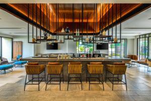 a lobby with a bar with chairs and a kitchen at Fairfield by Marriott Goa Benaulim in Benaulim