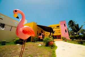 a statue of a flamingo in front of a building at Hotel Flamingos Inn in Chuburná