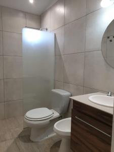 a bathroom with a toilet and a sink and a mirror at La escondida in San Rafael