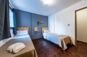 a room with two beds and a mirror at Viaggiato Nueva Cordoba in Cordoba