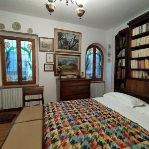 a bedroom with a bed with a colorful quilt at Rua dell'arco n.11 in Ascoli Piceno