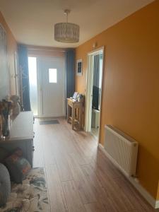 a living room with a wooden floor and yellow walls at 'Kodi's Place' Well appointed 1 bedroom apartment with excellent transport links and free Wi-Fi in Whiteabbey