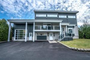 une grande maison avec une allée en face de celle-ci dans l'établissement Loft Nid d’amour, à Québec