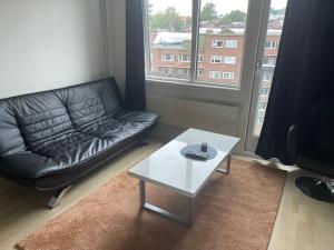 a living room with a leather couch and a coffee table at Oslo Center 5 in Oslo