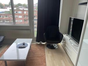 a room with a chair and a table and a window at Oslo Center 5 in Oslo