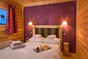 a bedroom with a bed with a tray of fruit on it at Chalet Ana in Les Angles