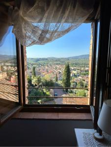 a window with a view of a city at Antica Torre del Borgo in Certaldo