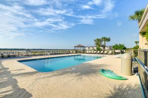 a swimming pool with a frisbee on the ground at Coastal Murrells Inlet Condo with Balcony! in Myrtle Beach