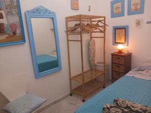 a bedroom with a mirror and a dresser and a bed at Habitación privada con baño. in Cádiz