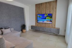 - un salon avec un canapé et une télévision murale dans l'établissement Apartamento en Finestrat, à Finestrat