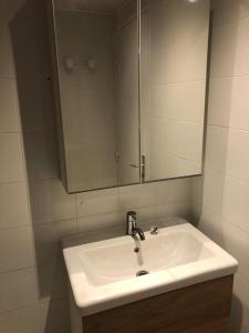 a bathroom with a white sink and a mirror at Studio Tignes Val Claret in Tignes