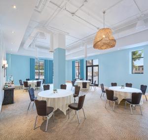 a large room with tables and chairs in it at Margaritaville Hotel San Diego Gaslamp Quarter in San Diego