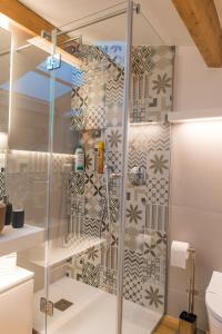 La salle de bains est pourvue d'une douche avec une porte en verre. dans l'établissement White Home, à Castellammare del Golfo