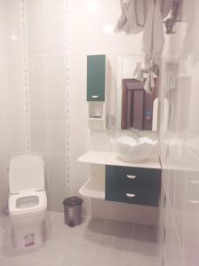 a white bathroom with a toilet and a sink at Chinar in Göyçay