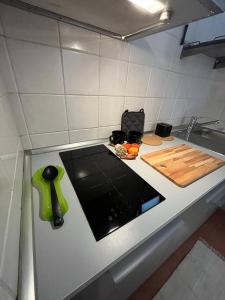 a kitchen with a counter top with a cutting board at Villa Blu in Frascati