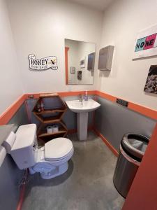 a bathroom with a toilet and a sink at Hive Check - Safari Tent - BeeWeaver Honey Farm in Navasota