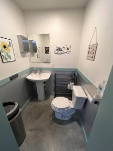 a bathroom with a toilet and a sink at Hive Check - Safari Tent - BeeWeaver Honey Farm in Navasota