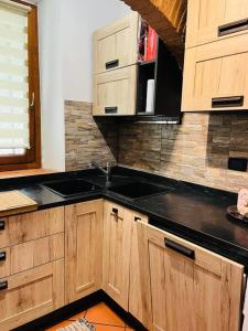 a kitchen with a sink and wooden cabinets at Casa Maria in Galluzzo +9 photos
