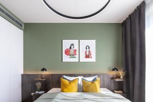 a bedroom with a large bed with yellow pillows at TurnKey I Central Apartment with Terrace in Prague